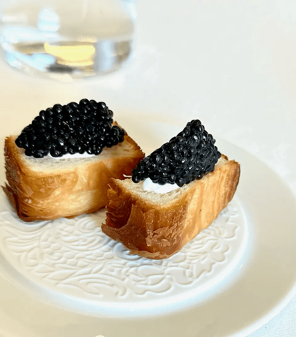 Brioche toasts topped with cream and caviar
