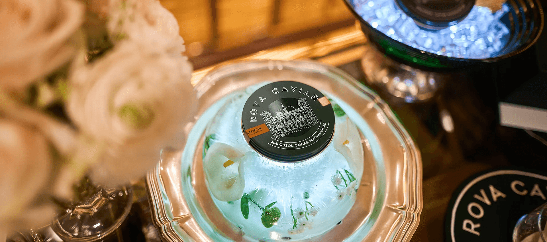 Illuminated ice dome decorated with various white flowers