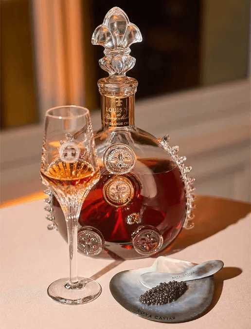 Louis XIII Cognac service with a glass of cognac, a spoon, and a mother-of-pearl spoon