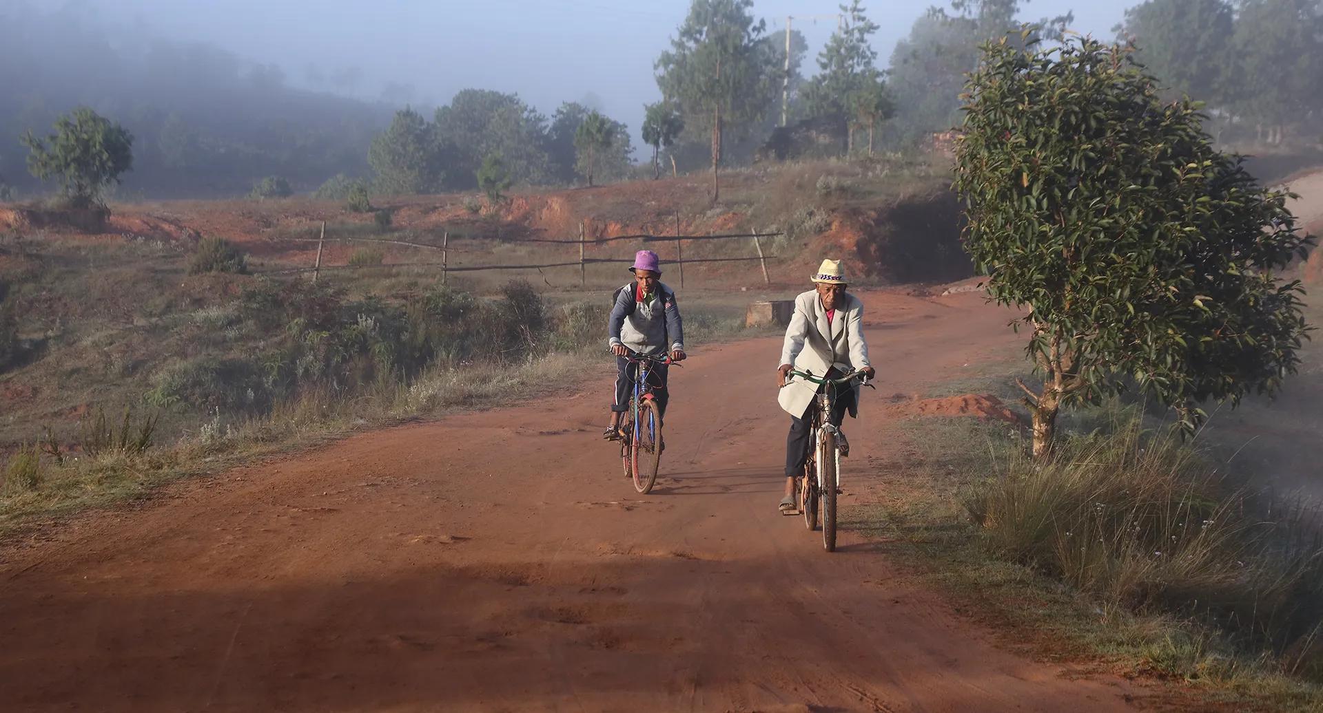 People returning from work on bicycles in nature