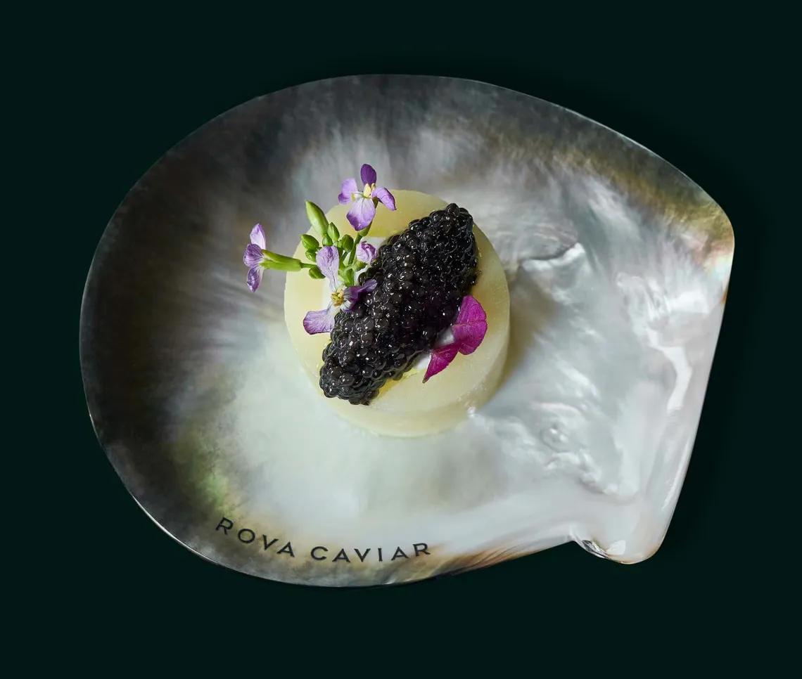 Potato bite with Rova Caviar and edible flower recipe, top view