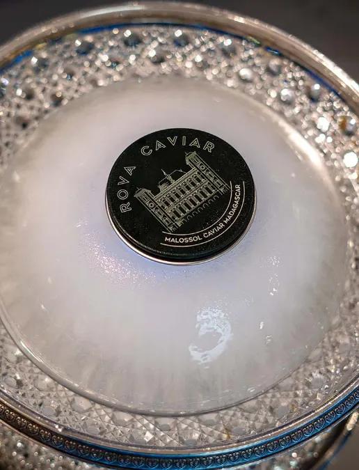 Luminous ice dome, closed caviar box, and silverware