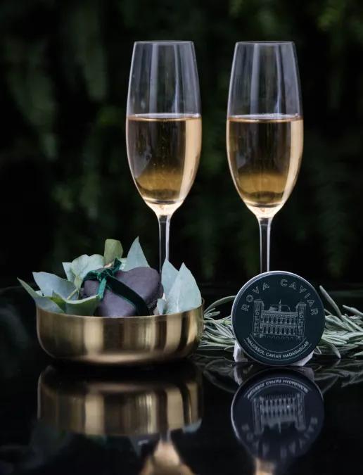 Two champagne glasses with caviar box
