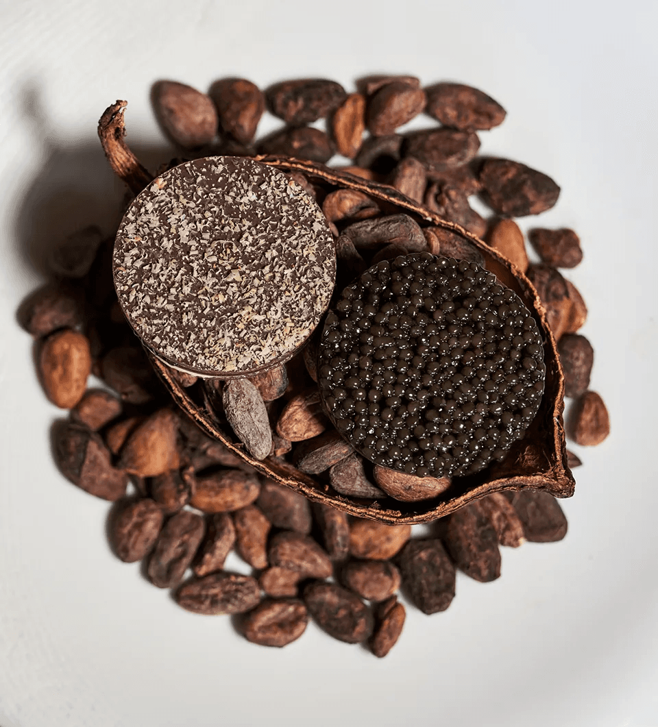Chocolate and Ossetra caviar crisp on a bed of cocoa beans